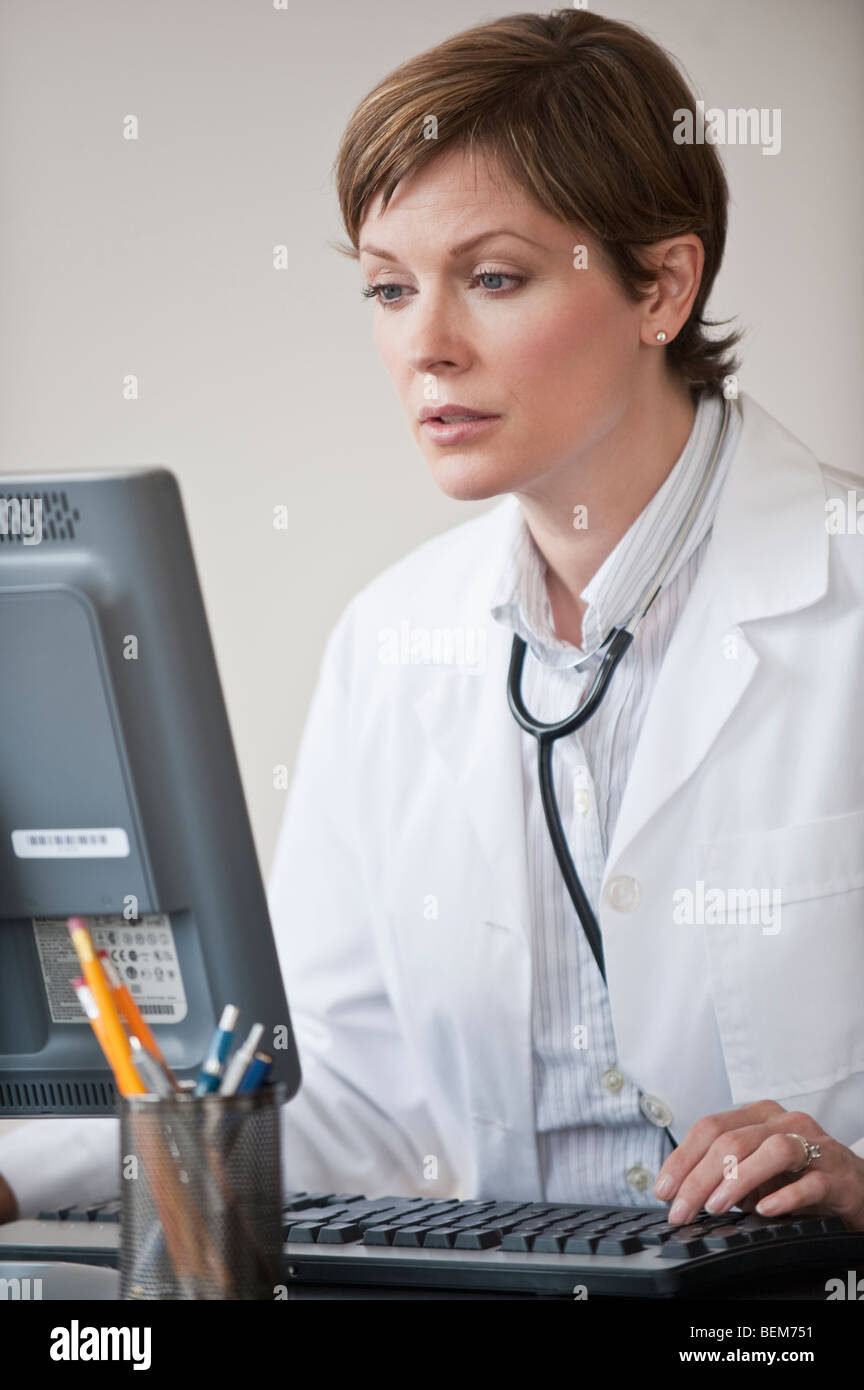 Female doctor working on laptop Stock Photo