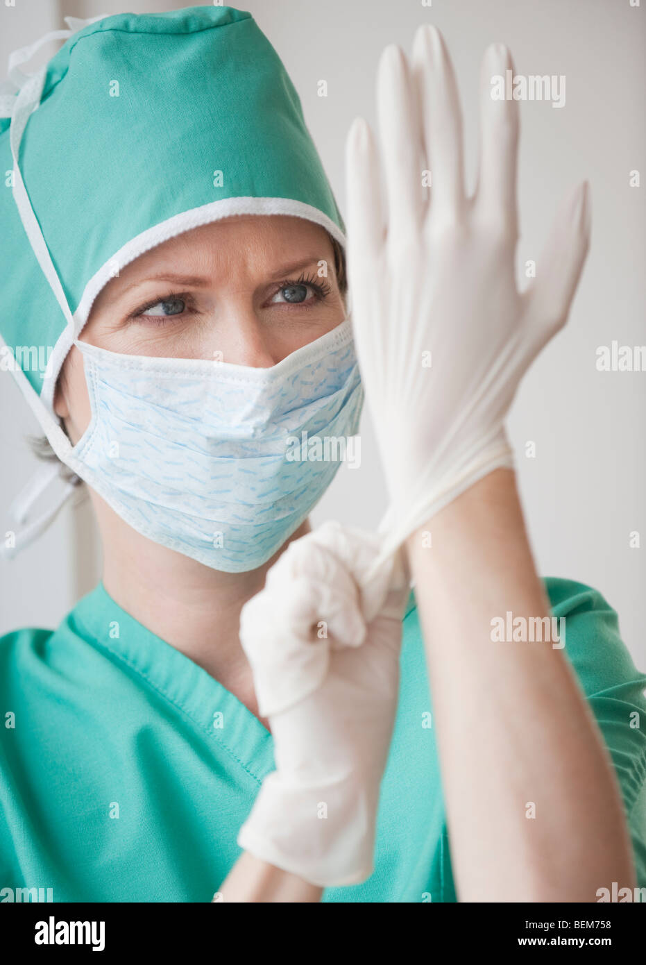 Female doctor putting on gloves Stock Photo