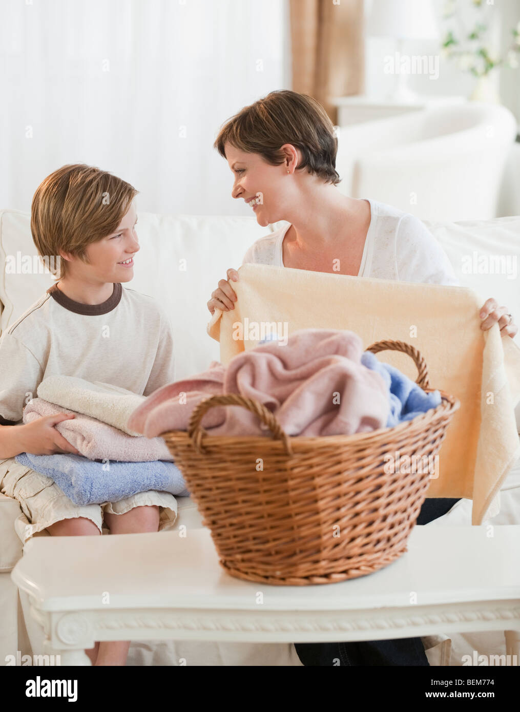 Mother and child folding laundry Stock Photo Alamy