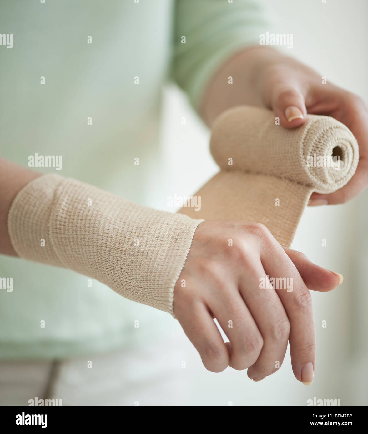 Wrapping hand in tensor bandage Stock Photo Alamy