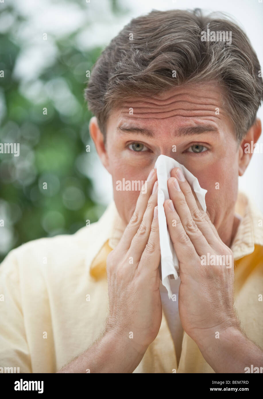 Man blowing nose Stock Photo Alamy