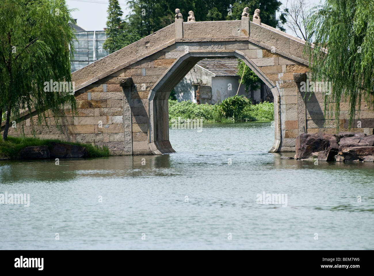 Ancient stone bridge with two willows Xitang is an ancient scenic town in Jiashan County, Zhejiang Province, China. Stock Photo