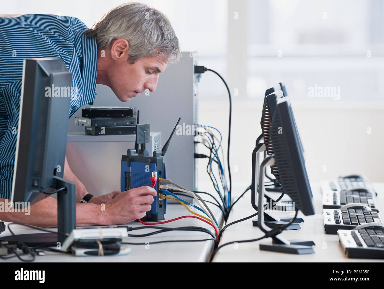 Man with networked computers Stock Photo