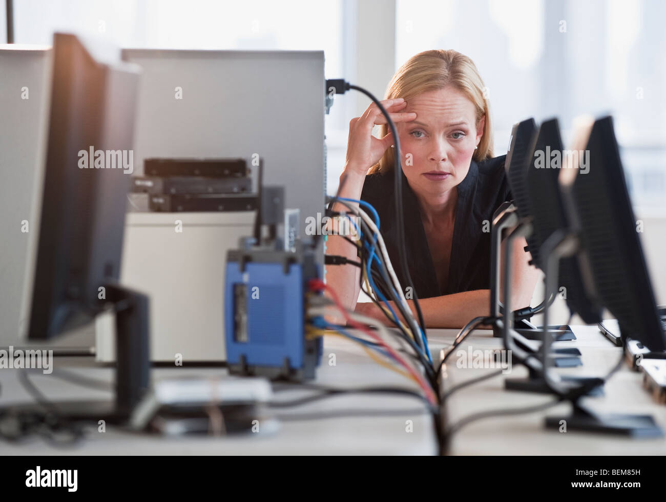 Woman with networked computers Stock Photo