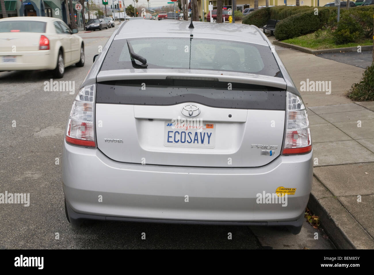 Rear view of a Toyota Prius with a 'ECOSAVY' (Eco Savvy license plate and a clean air vehicle sticker. Stock Photo