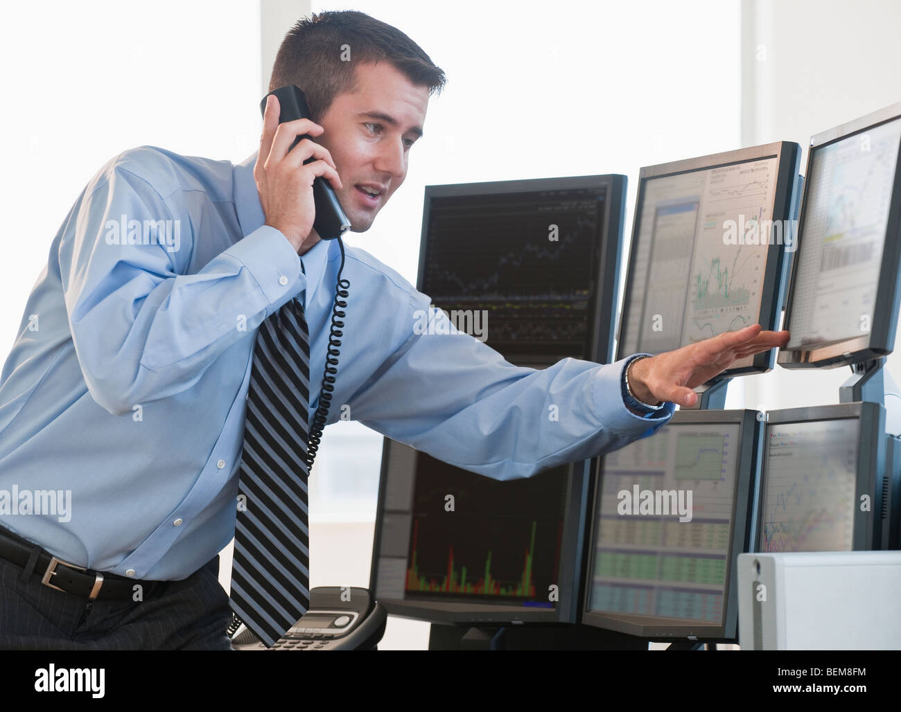 Trader studying computer screens Stock Photo