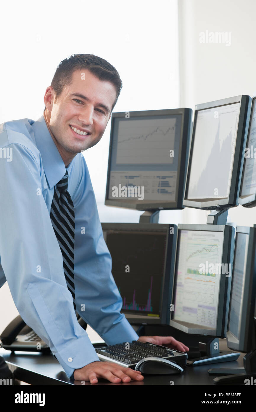 Trader at computer screens Stock Photo