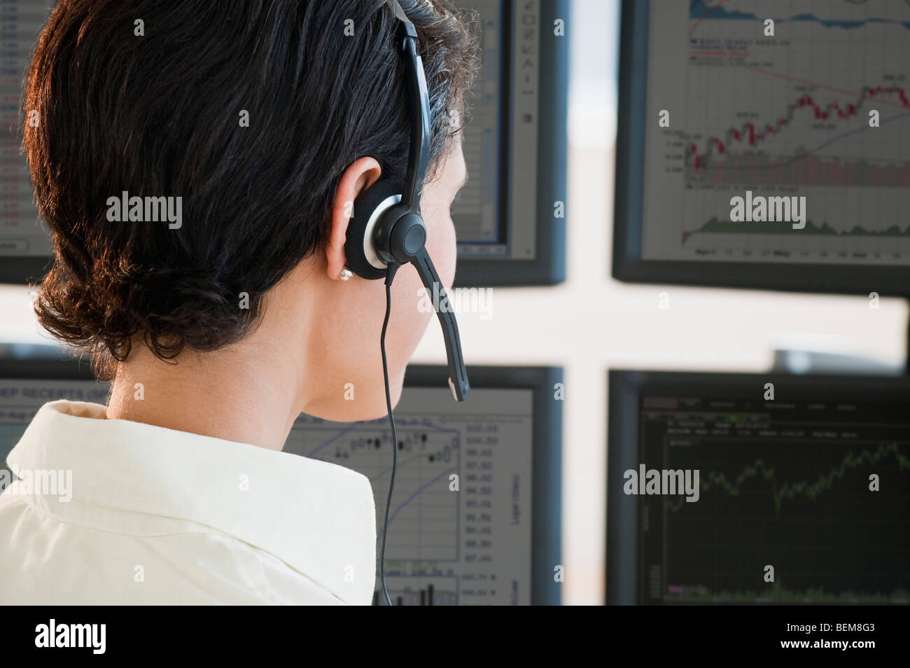 Female trader studying screens Stock Photo