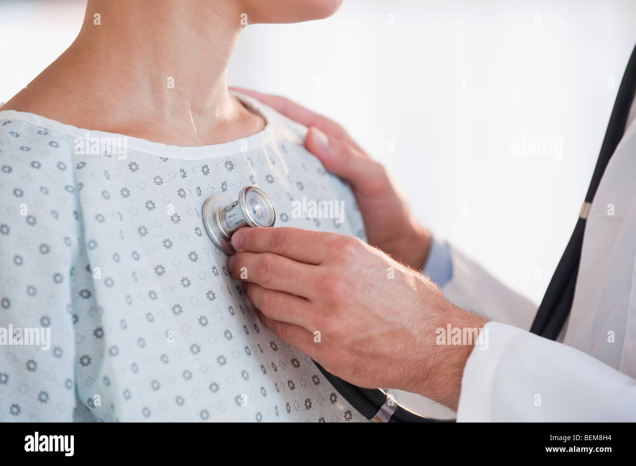 Doctor checking patient with stethoscope Stock Photo