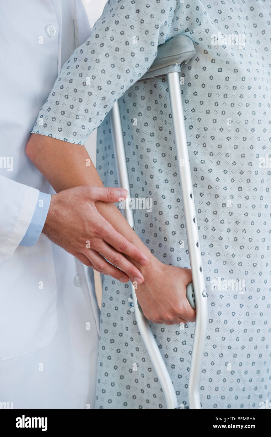 Doctor and patient with crutches Stock Photo