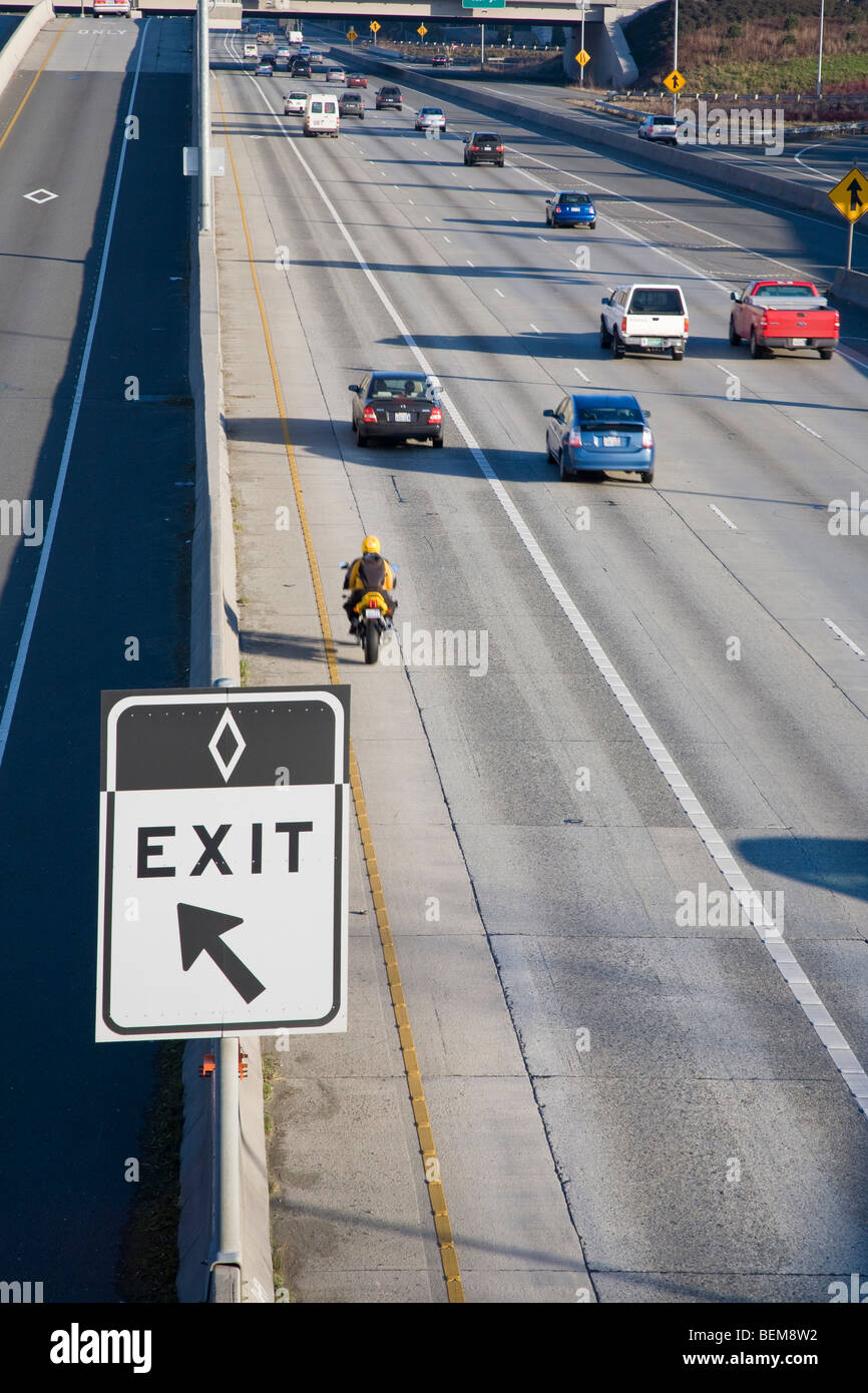 A carpool only exit sign on Highway 405 with cars driving in background. Bellevue, Washington, USA Stock Photo