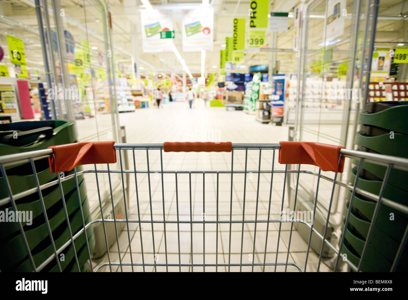 Entering supermarket with shopping cart Stock Photo