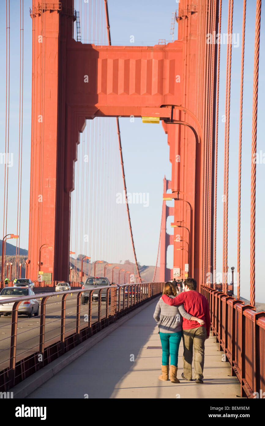 A rear view of a couple walking on the Golden Gate Bridge. San Francisco, California, USA Stock Photo
