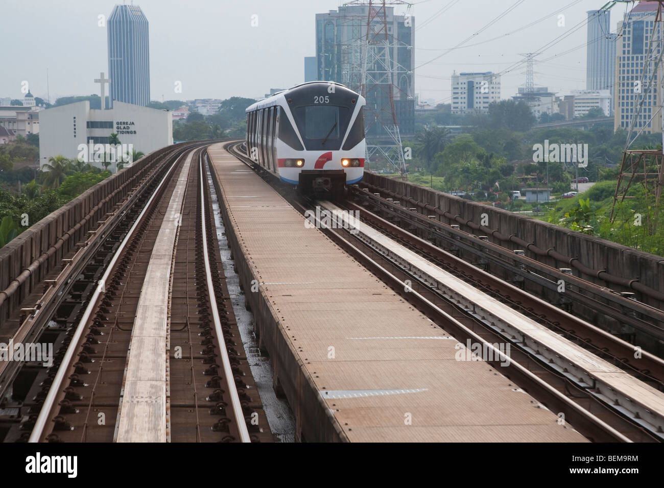 RapidKL train on elevated railway with Kuala Lumpur in background. Kuala Lumpur, Selangor, Malaysia Stock Photo