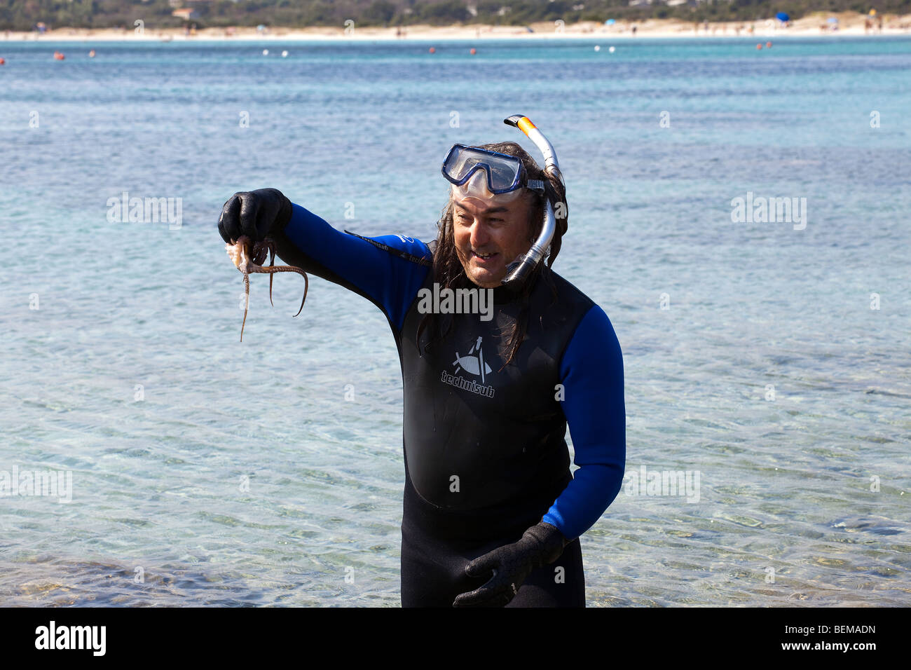 man fishing an octopus in Sardinia, Italy. Snorkeling Stock Photo