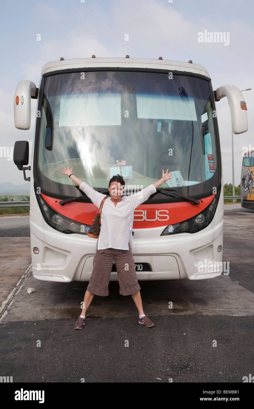 A mid adult woman excited about taking the bus from Kuala to Singapore. Kuala Lumpur, Selangor, Malaysia Stock Photo
