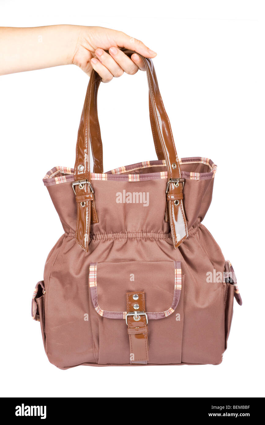 Holding a brown handbag isolated on white background Stock Photo - Alamy