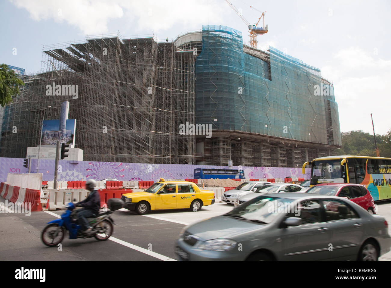 Traffic crossing Orchard Road in Singapore. In background is the construction site of ION Orchard and The Orchard Residences. Stock Photo