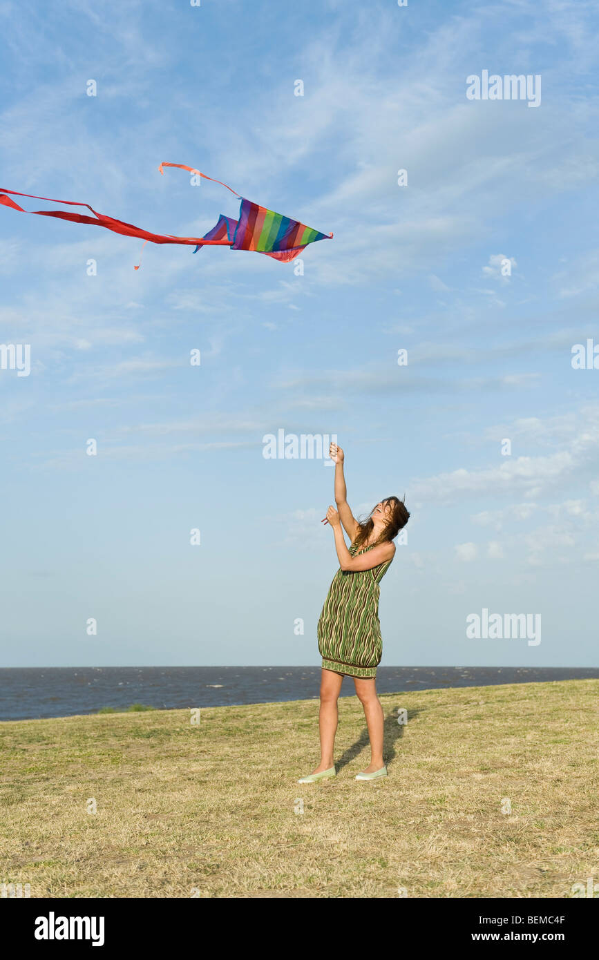 Woman flying kite Stock Photo