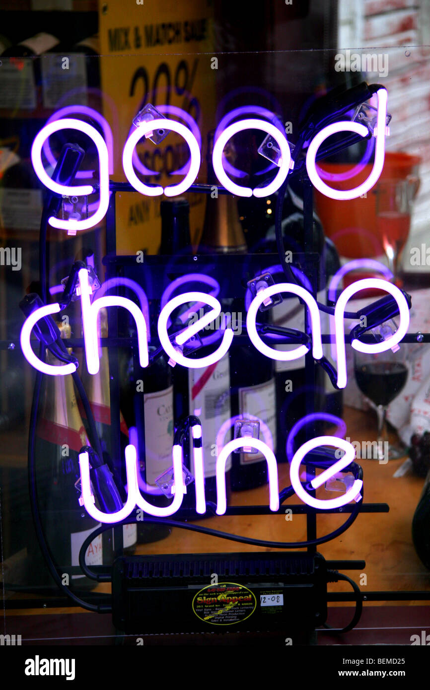 Good cheap wine neon sign in liquor store window Stock Photo