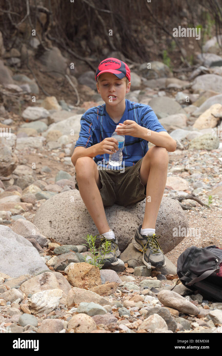 Boy Taking a Water Break on Hike - Age 12 - Arizona - USA Stock Photo