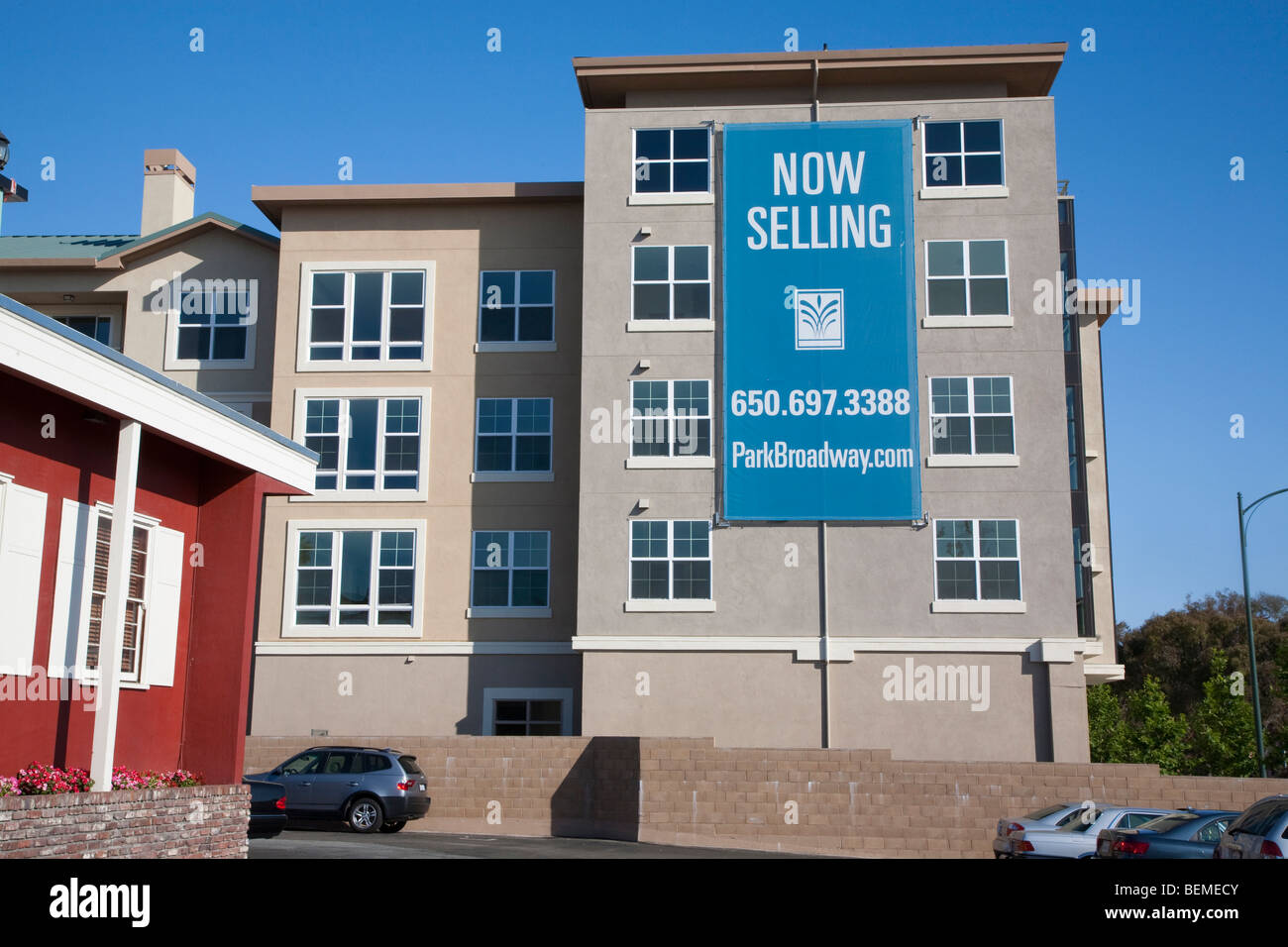 An advertising sign on a mixed used housing development. El Camino Real in Millbrae, CA, USA Stock Photo