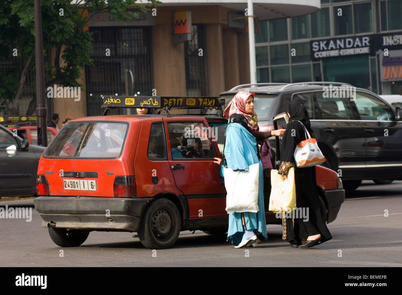 Muslim women negotiate with a taxi driver on the day of a taxi strike, Casablanca, Morocco, Africa Stock Photo