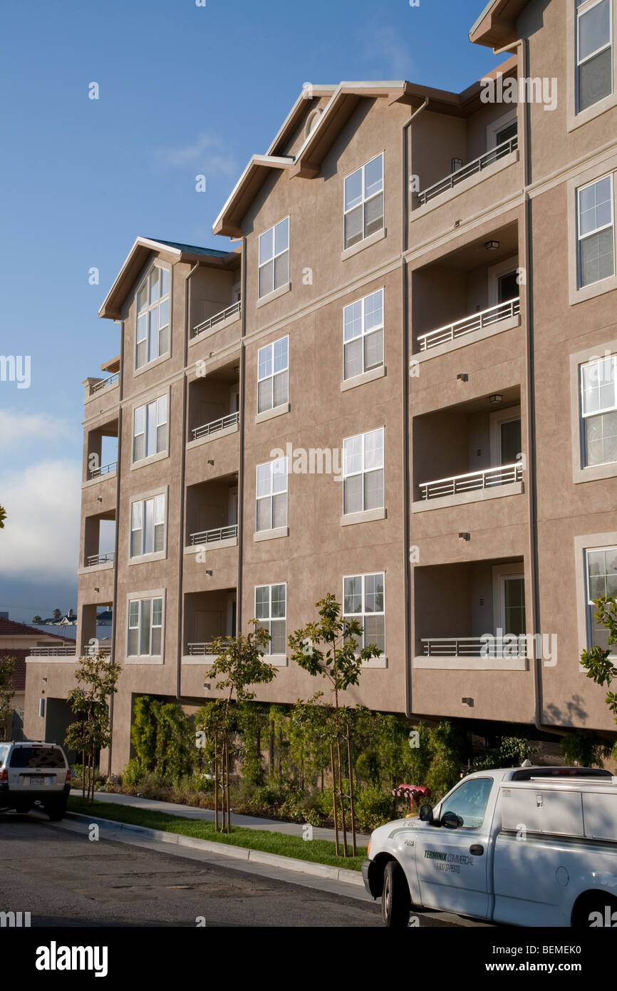 A newly built compact housing development lined with trees. Park