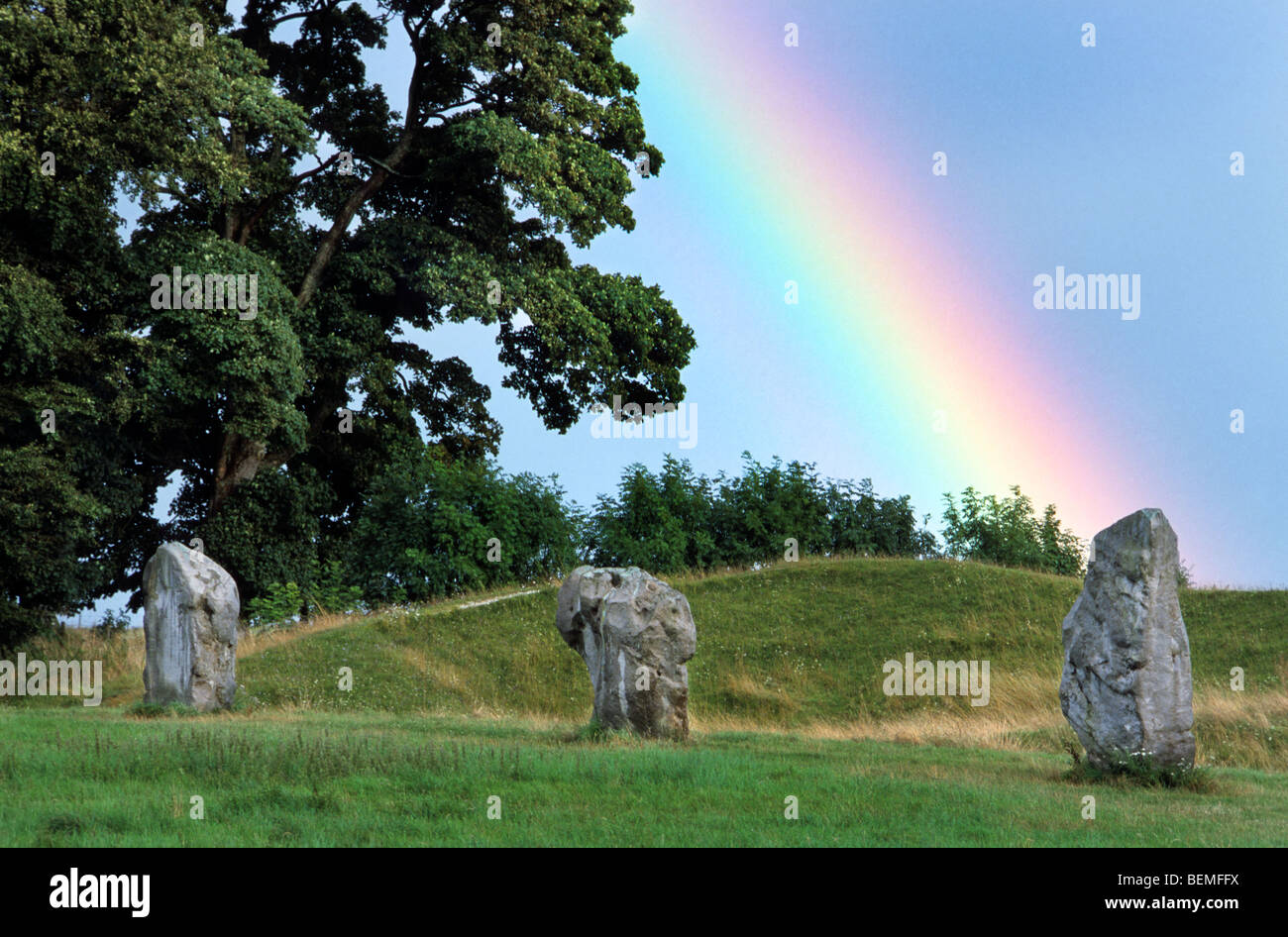 Rainbow and megaliths / standing stones of stone circle at Avebury, Wiltshire, UK Stock Photo