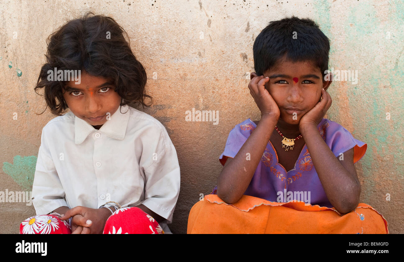 Young Indian street girls leaning against a wall Stock Photo