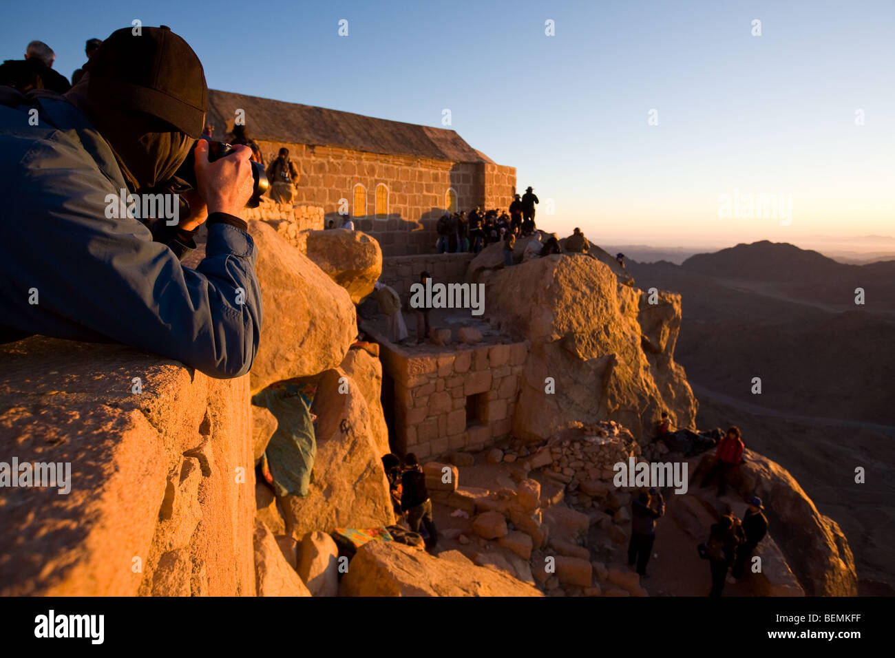 Photographer photographing people gathered at church at dawn after the early morning trek to Mount Sinai, Egypt, Middle East Stock Photo