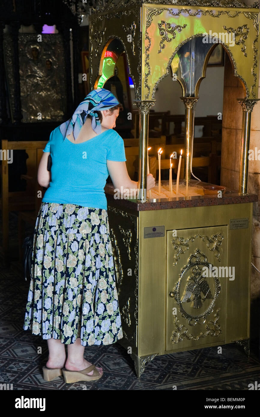 Woman lighting a candle inside the GreekOrthodox church in Lefkara, Cyprus Stock Photo Alamy