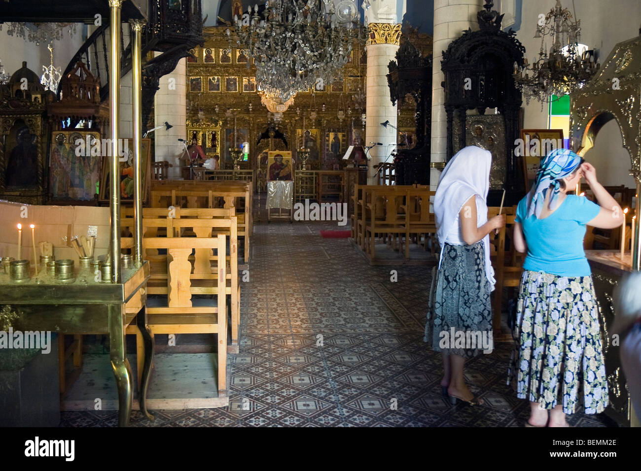 Women lighting candles in the GreekOrthodox church in Lefkara, Cyprus