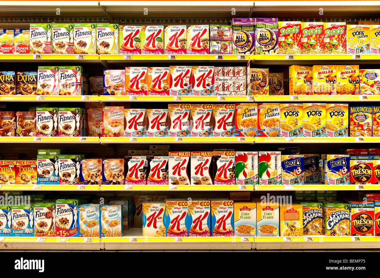 Boxes of branded breakfast cereals on supermarket shelves - France. Stock Photo