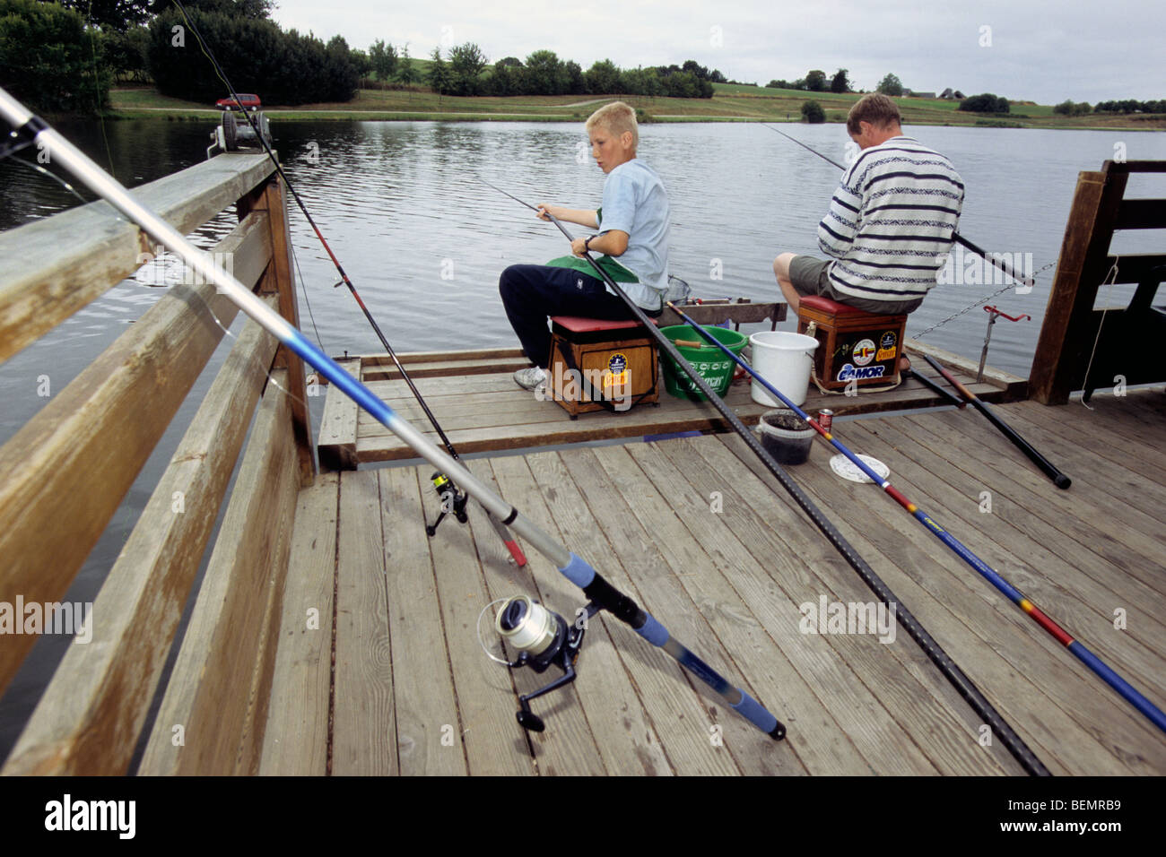Anglers along border of lake, Belgium Stock Photo