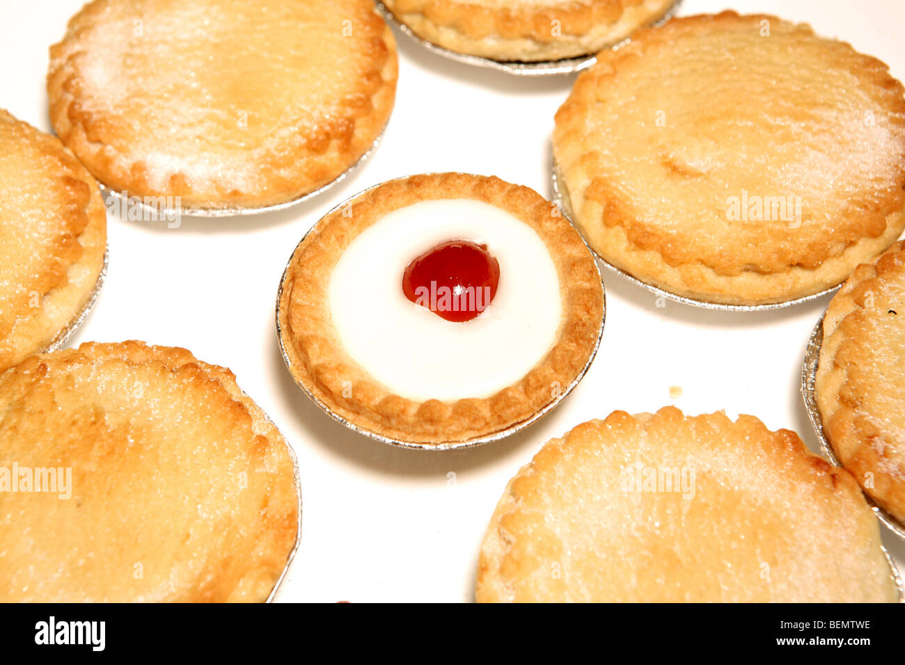 Mince pies surrounding a bakwell tart Stock Photo