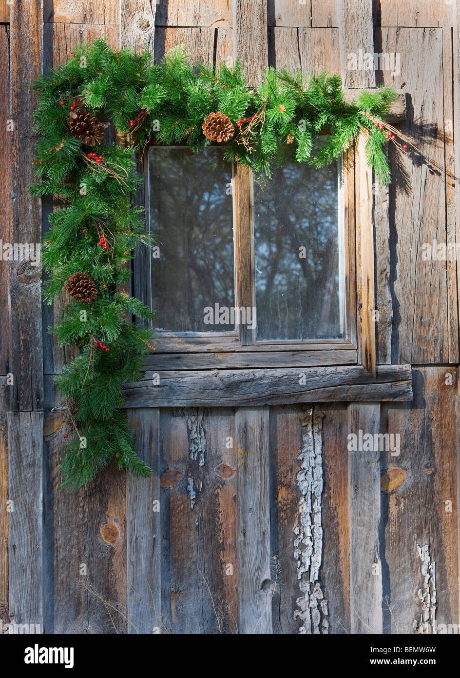 Christmas holiday decoration trim around an old house or barn. Stock Photo