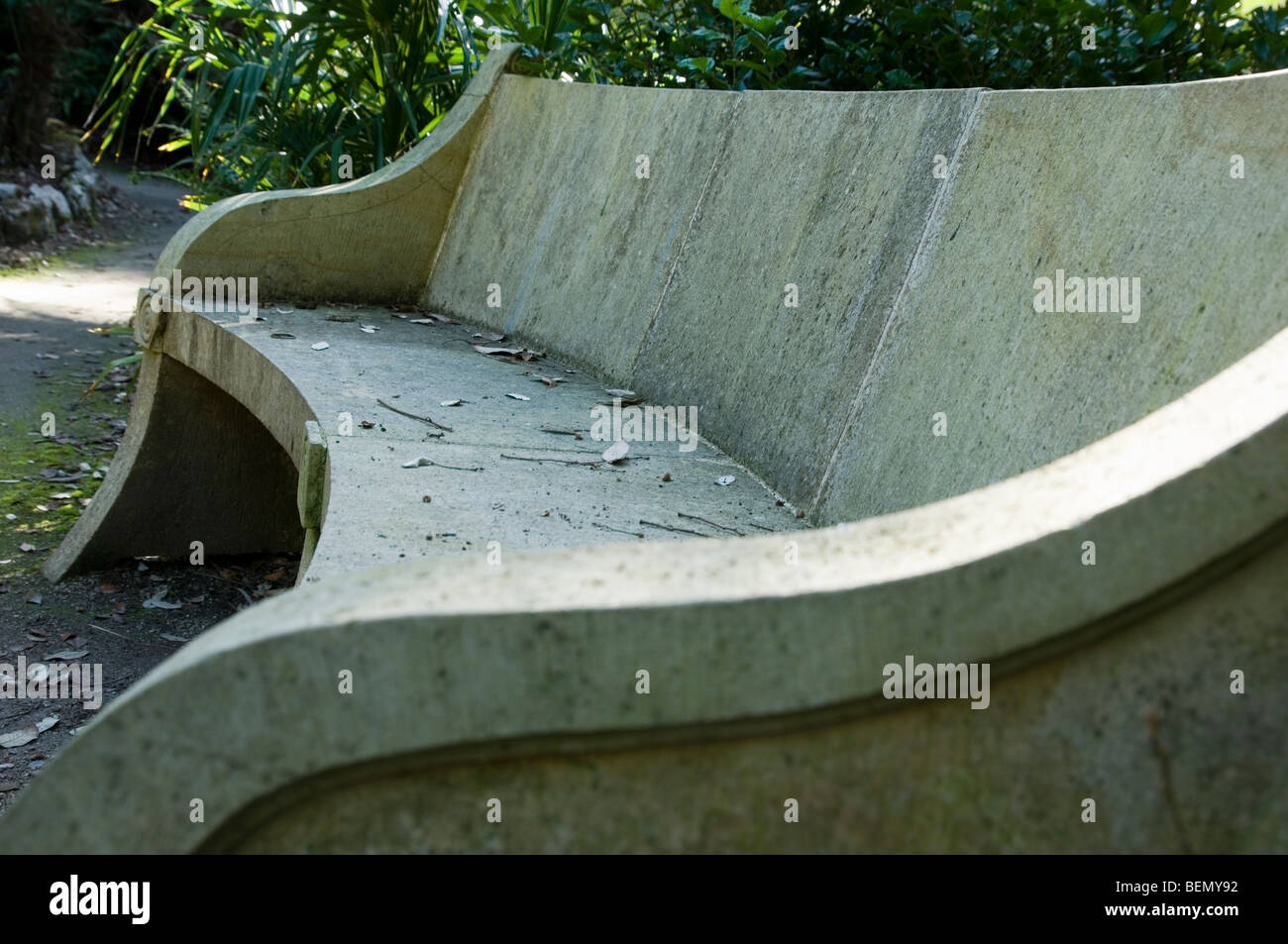 Sandstone Garden Bench Littered With Autumn Leaves And Foliage And