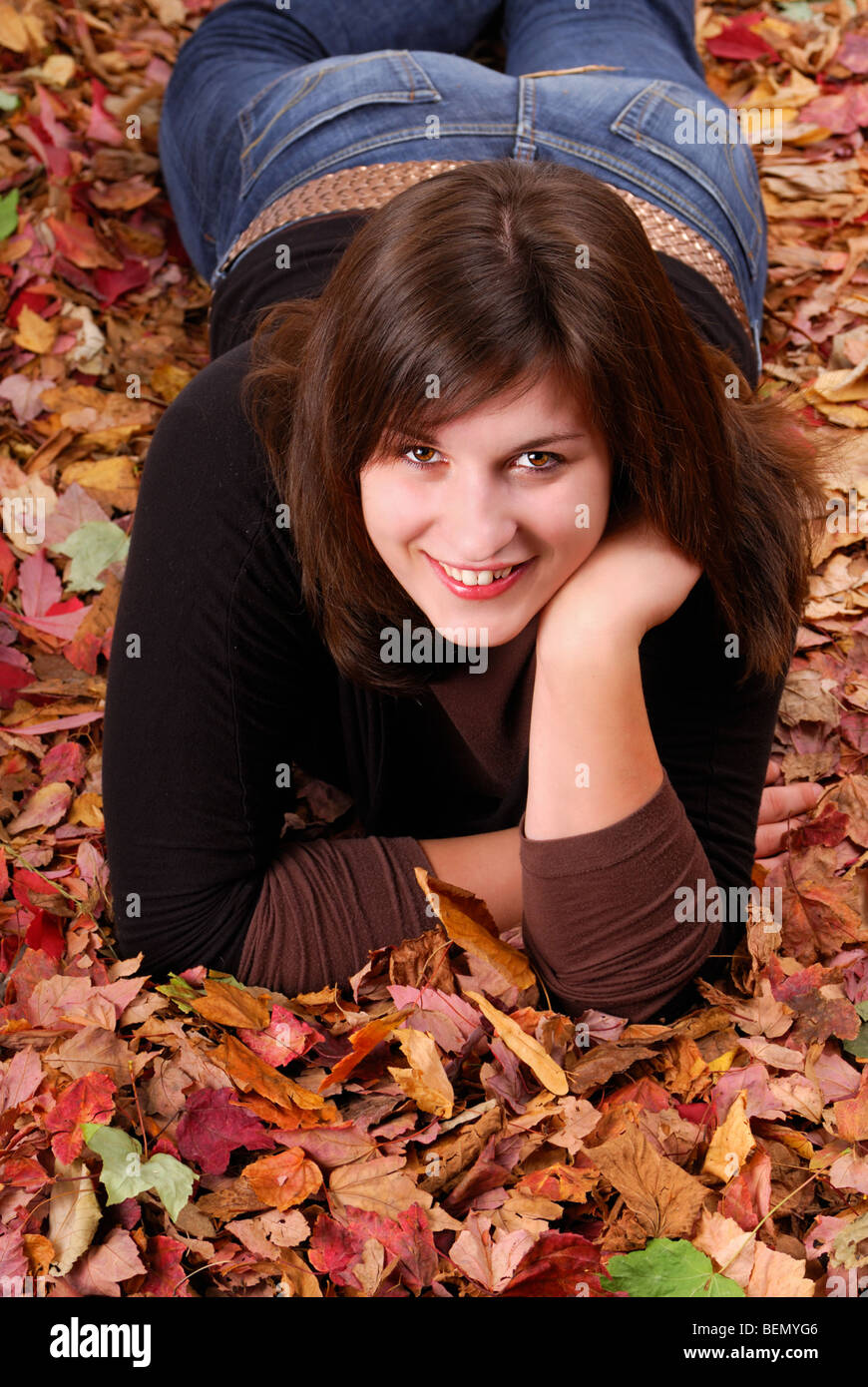 young woman lying in colored autumn leaves Stock Photo - Alamy