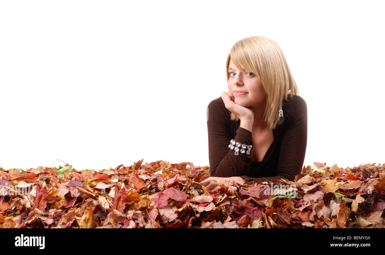 young blond woman lying in colored autumn leaves Stock Photo - Alamy