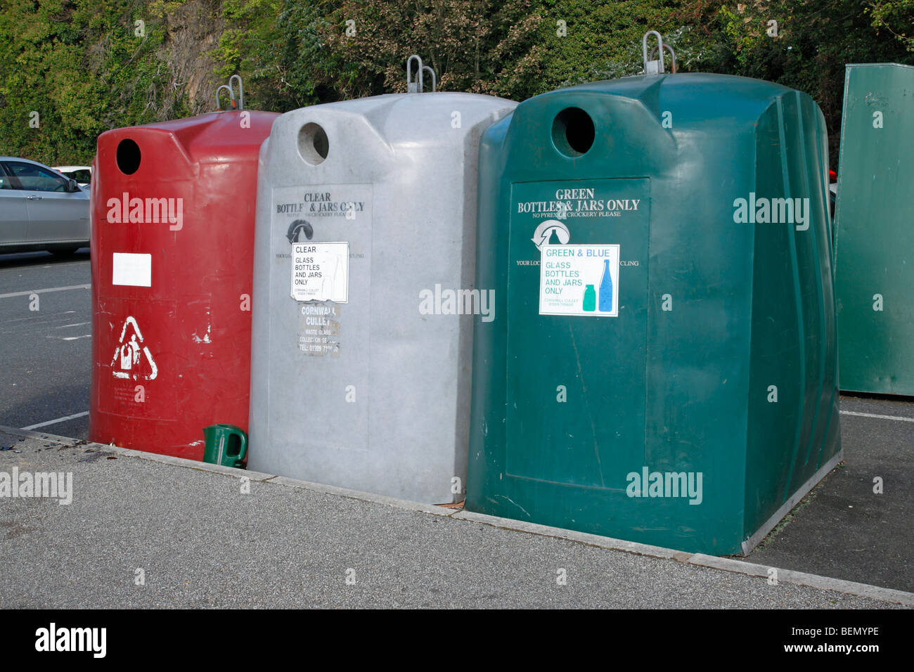 Three glass bottle and jar recycling bins in a car park Stock Photo Alamy