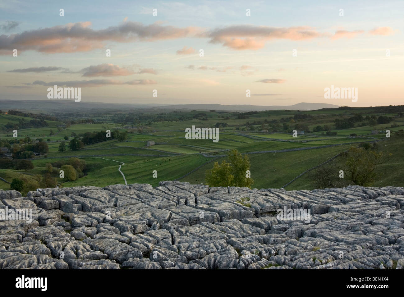 Sunset at Malham Cove, looking towards the village of Malham in the Yorkshire Dales National Park, North Yorkshire UK Stock Photo