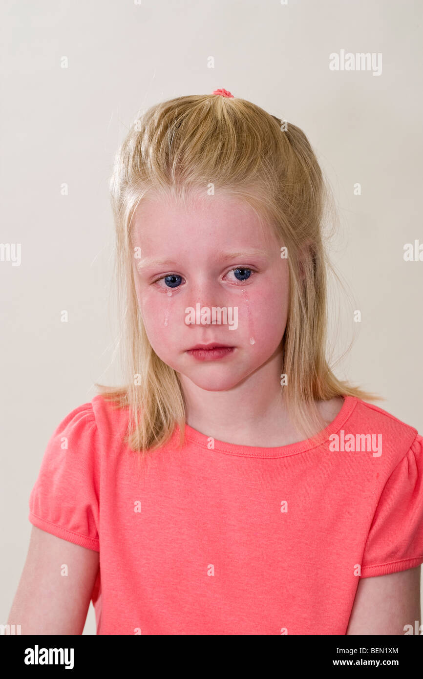 6 year old girl crying with deep sadness.grief facial expression emotional emotions emotion anger angry resentment resentful mad Stock Photo