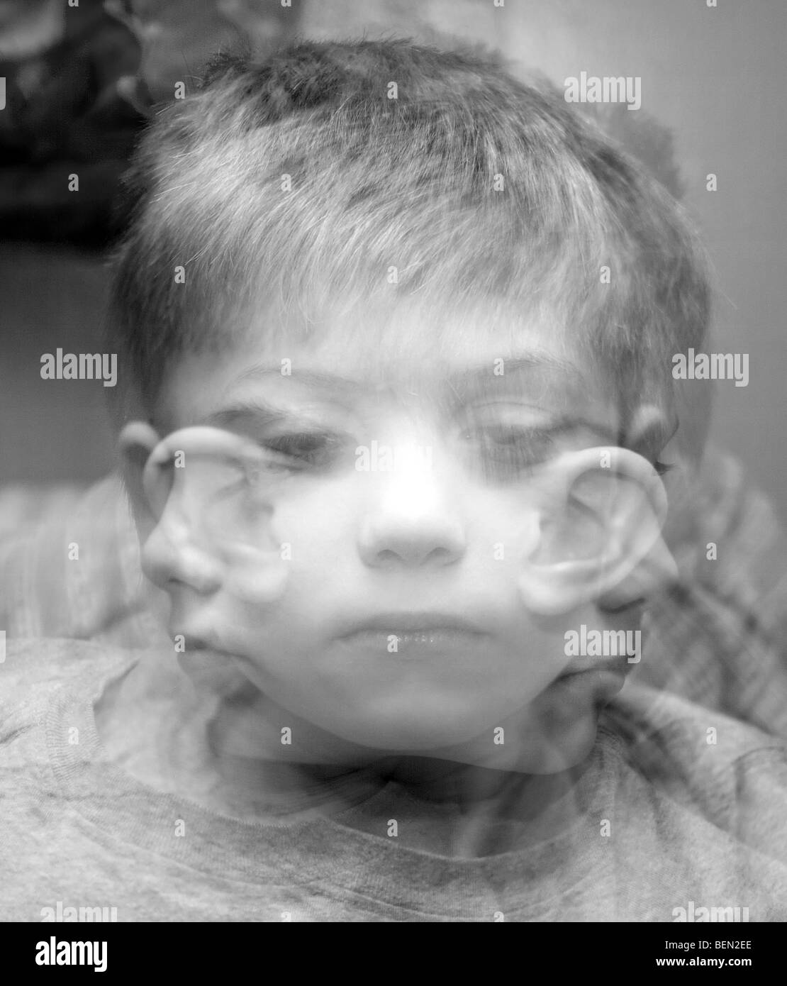 A Triple exposure depicting a small boy looking in three different directions Stock Photo