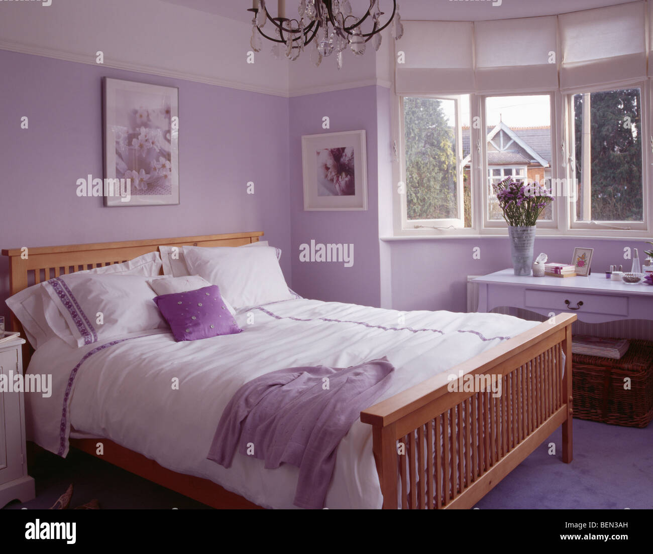 White Pillows And Bedlinen On Wooden Bed In Mauve Bedroom