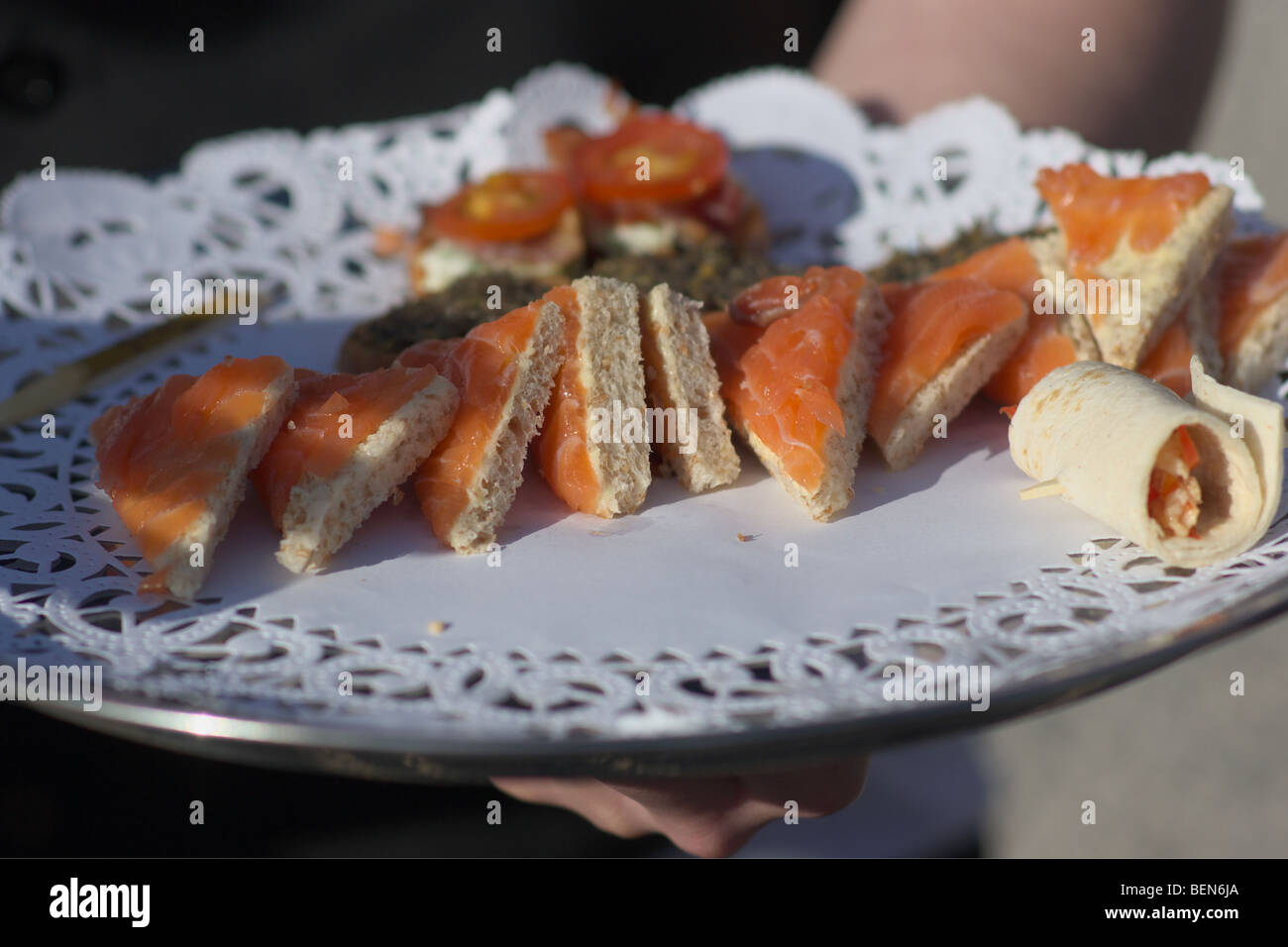 A tray of smoked salmon canapés served at a garden party Stock Photo