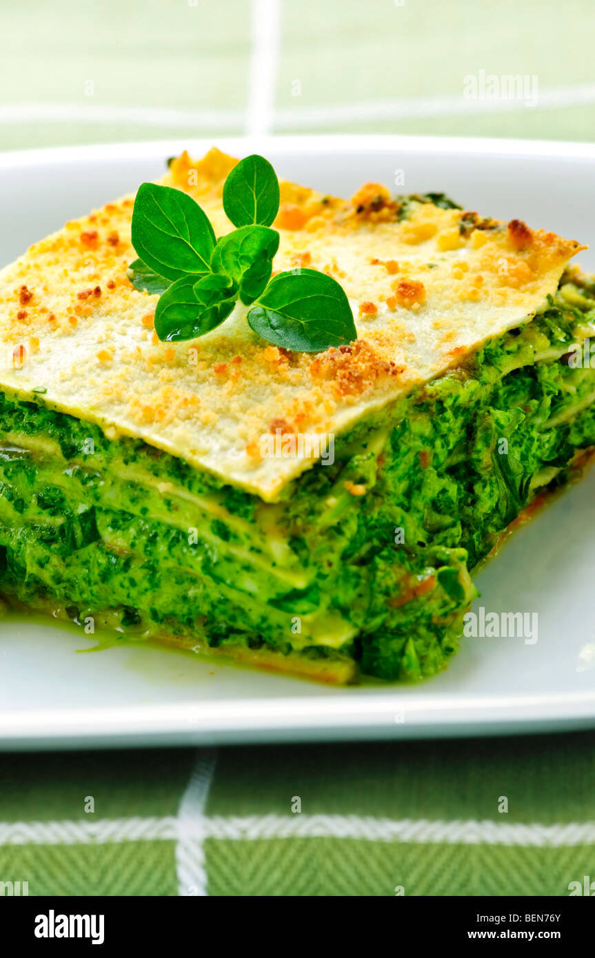 Serving of fresh baked vegeterian spinach lasagna on a plate Stock Photo