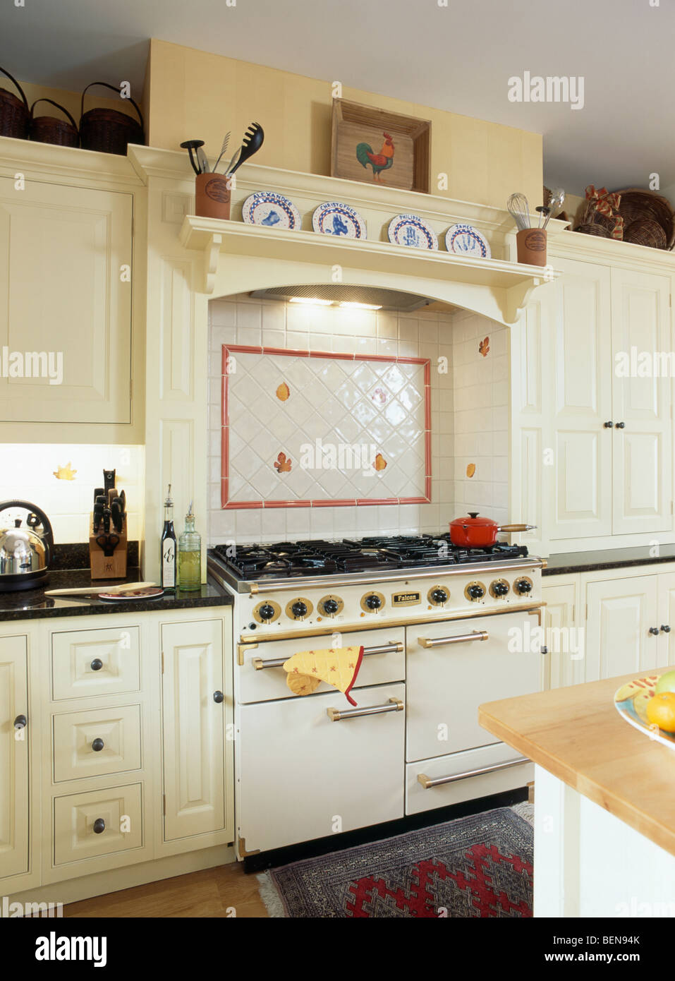 White and red wall tiles above white range oven in traditional white kitchen Stock Photo