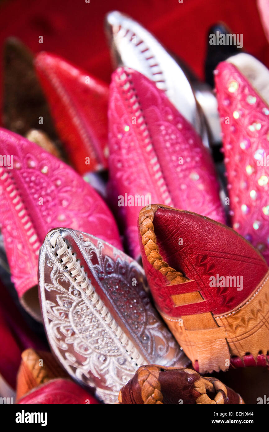 Colourful traditional Moroccan leather slippers shoes and babouches on display in a shop in the