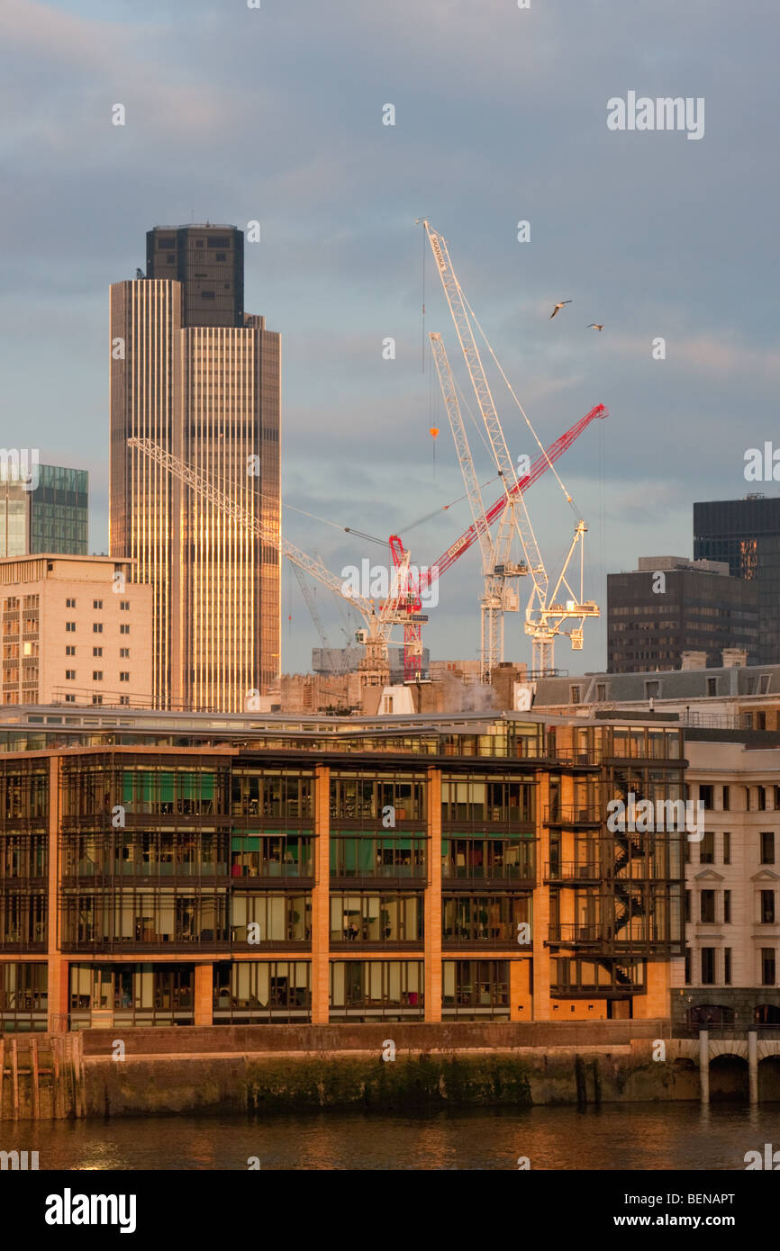 Natwest Tower (Tower 42) seen from the River Thames with construction cranes nearby, London, February 2009 Stock Photo